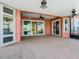 Spacious covered patio with ceiling fans, sliding glass doors, and views at 513 Viterra Ct, Kissimmee, FL 34759