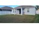 Large backyard with grassy area and covered patio at 12254 Sandy Apple Rd, Orlando, FL 32824