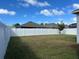 Large backyard with a grassy area and white privacy fence at 12254 Sandy Apple Rd, Orlando, FL 32824