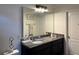 Bathroom with granite vanity, large mirror, and modern lighting at 12254 Sandy Apple Rd, Orlando, FL 32824