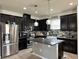 Spacious kitchen with dark wood cabinets, granite island, and stainless steel appliances at 12254 Sandy Apple Rd, Orlando, FL 32824