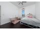 Bright bedroom with a queen-size bed, dark hardwood floors, and a window with blinds at 1542 Sun Meadow Dr, Orlando, FL 32824
