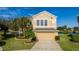Two-story house with a neutral exterior, landscaped yard, and a two-car garage at 1542 Sun Meadow Dr, Orlando, FL 32824
