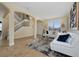 Open living room with a staircase, white couches, and tile floors at 1542 Sun Meadow Dr, Orlando, FL 32824
