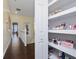 Upstairs hallway with a built-in storage closet and hardwood floors at 1542 Sun Meadow Dr, Orlando, FL 32824