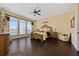 Large main bedroom with a king-size bed, dark hardwood floors, and large windows at 1542 Sun Meadow Dr, Orlando, FL 32824