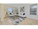 Bright living room with white couches, a large abstract art piece, and tile floors at 1542 Sun Meadow Dr, Orlando, FL 32824