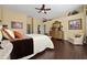 Main bedroom with king-size bed, dresser, and hardwood floors at 1542 Sun Meadow Dr, Orlando, FL 32824