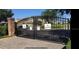 Gated community entrance with brick pillars at 1542 Sun Meadow Dr, Orlando, FL 32824