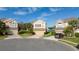 Three-story houses in a cul-de-sac neighborhood with palm trees and a lake view at 1542 Sun Meadow Dr, Orlando, FL 32824