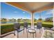 Relaxing patio overlooking a lake with wicker furniture at 1542 Sun Meadow Dr, Orlando, FL 32824