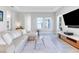 Relaxing living room with sectional sofa and large windows at 13010 Stoddart Ave, Orlando, FL 32827