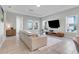 Open living area featuring a sectional sofa and ample natural light at 13010 Stoddart Ave, Orlando, FL 32827