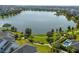Aerial view of a lakefront community with a pool at 13010 Stoddart Ave, Orlando, FL 32827