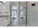 Bathroom with walk-in shower, granite vanity, and view of bedroom at 13010 Stoddart Ave, Orlando, FL 32827