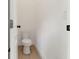 Small half bathroom with a toilet and wood-look tile floor at 13010 Stoddart Ave, Orlando, FL 32827