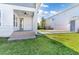 Private backyard with a covered patio and a spacious grassy area at 13010 Stoddart Ave, Orlando, FL 32827