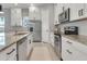 Modern kitchen with stainless steel appliances and granite countertops at 13010 Stoddart Ave, Orlando, FL 32827