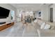 Bright living room features a large sectional sofa and an open floor plan at 13010 Stoddart Ave, Orlando, FL 32827