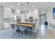 Open kitchen with island, dining area, and stainless steel appliances at 13010 Stoddart Ave, Orlando, FL 32827