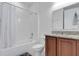 Clean bathroom with tub, shower, vanity, and granite countertop at 13010 Stoddart Ave, Orlando, FL 32827