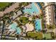 Aerial view of community pool area, showing various pools, lounge areas, and a basketball court at 13010 Stoddart Ave, Orlando, FL 32827