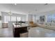 Open living area with kitchen island, seating area, and baby gate at 13010 Stoddart Ave, Orlando, FL 32827
