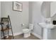 Modern powder room with pedestal sink and stylish shelving at 13010 Stoddart Ave, Orlando, FL 32827