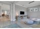 Bright playroom with built-in shelving, comfortable seating, and a view into the living area at 13010 Stoddart Ave, Orlando, FL 32827
