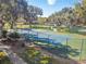 Community tennis court surrounded by lush landscaping at 3381 Marshfield Preserve Way, Kissimmee, FL 34746