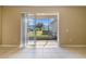 Screened patio with sliding glass doors and backyard view at 3381 Marshfield Preserve Way, Kissimmee, FL 34746
