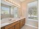 Bathroom with double vanity, large mirror, and window at 3381 Marshfield Preserve Way, Kissimmee, FL 34746
