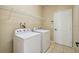 Laundry room with washer, dryer, and overhead shelving at 3381 Marshfield Preserve Way, Kissimmee, FL 34746