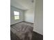 Spacious bedroom with gray carpet and large window at 2893 Fitness St, Clermont, FL 34714
