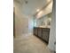 Bathroom with double vanity, large mirror, and shower at 2893 Fitness St, Clermont, FL 34714