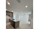 Modern kitchen with island, stainless steel appliances, and ample counter space at 2893 Fitness St, Clermont, FL 34714