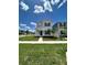 Two-story house with gray siding, blue door, and green lawn at 2893 Fitness St, Clermont, FL 34714