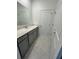 Bathroom with gray vanity, quartz countertop and tile flooring at 2893 Fitness St, Clermont, FL 34714