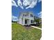 Two-story house with gray siding, blue door, and landscaped yard at 2893 Fitness St, Clermont, FL 34714