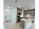 Modern kitchen with island, stainless steel appliances, and gray cabinets at 2893 Fitness St, Clermont, FL 34714