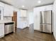 Modern kitchen with white cabinets and stainless steel appliances at 117 W Maple St, Davenport, FL 33837