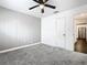 Bedroom with gray accent wall, ceiling fan, and view of kitchen at 117 W Maple St, Davenport, FL 33837