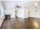 Large living area with hardwood floors, fireplace, and kitchen access at 117 W Maple St, Davenport, FL 33837