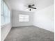 Spacious bedroom featuring a ceiling fan and ample natural light at 117 W Maple St, Davenport, FL 33837