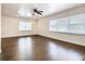 Spacious living room with hardwood floors and ceiling fan at 117 W Maple St, Davenport, FL 33837