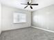 Bedroom with gray accent wall, ceiling fan, and neutral carpet at 117 W Maple St, Davenport, FL 33837