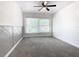 Spacious bedroom with ceiling fan, grey carpet, and large window at 117 W Maple St, Davenport, FL 33837