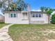 Front view of a renovated single story home with gray roof and white siding at 117 W Maple St, Davenport, FL 33837