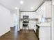 Modern kitchen with white cabinets and stainless steel appliances at 117 W Maple St, Davenport, FL 33837