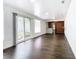 Bright living room features dark laminate floors and sliding glass doors to backyard at 117 W Maple St, Davenport, FL 33837